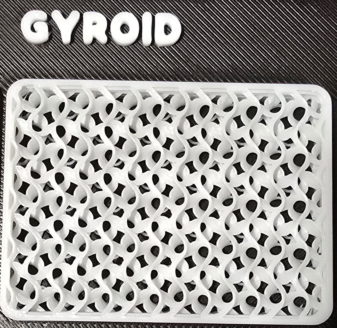 A close-up of gyroid infill showing its continuous wavy three-dimensional structure.